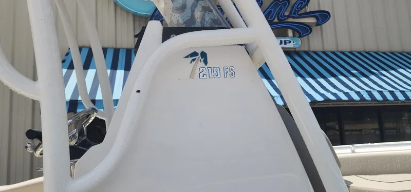 Slide: The Image of 2024 Key West 219fs boat detail with blue-striped awning background. - 11