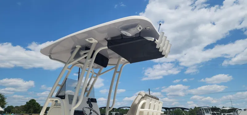Slide: The Image of 2024 Key West 219fs boat with T-top against a blue sky. - 12