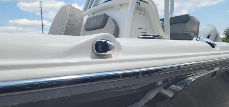 Slide: The Image of 2024 Key West 219fs boat, close-up of sleek white exterior and seating. - 13