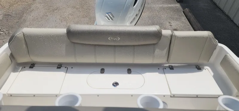 Slide: The Image of 2024 Key West 219fs boat interior with cushioned seating and storage compartments. - 14