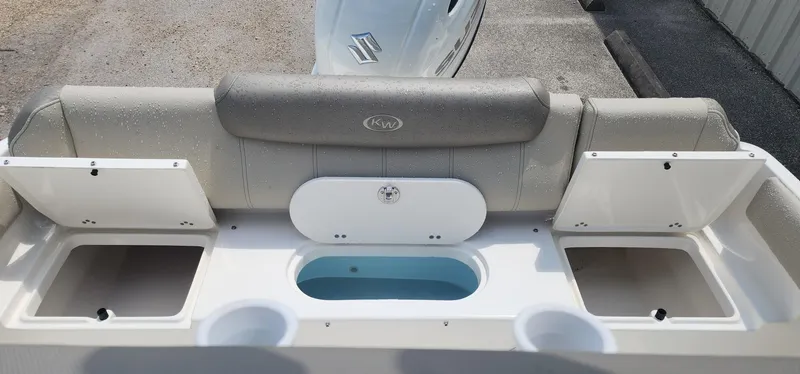 Slide: The Image of 2024 Key West 219fs boat interior with storage compartments and cushioned seating. - 15