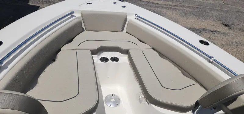 Slide: The Image of 2024 Key West 219fs boat interior with beige seating and stainless steel rails. - 17