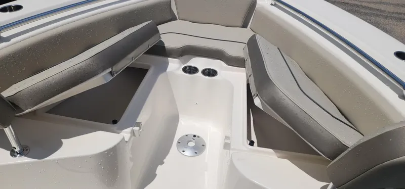 Slide: The Image of 2024 Key West 219fs boat interior with cushioned seating and storage compartments. - 18