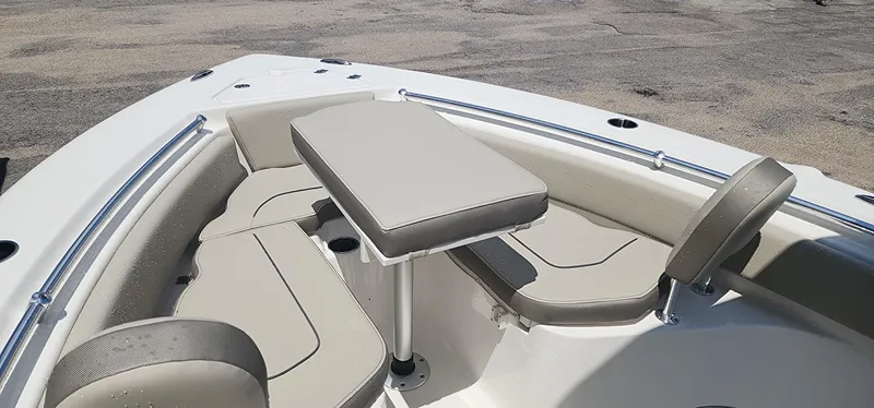 Slide: The Image of 2024 Key West 219fs boat interior with cushioned seating and table. - 19