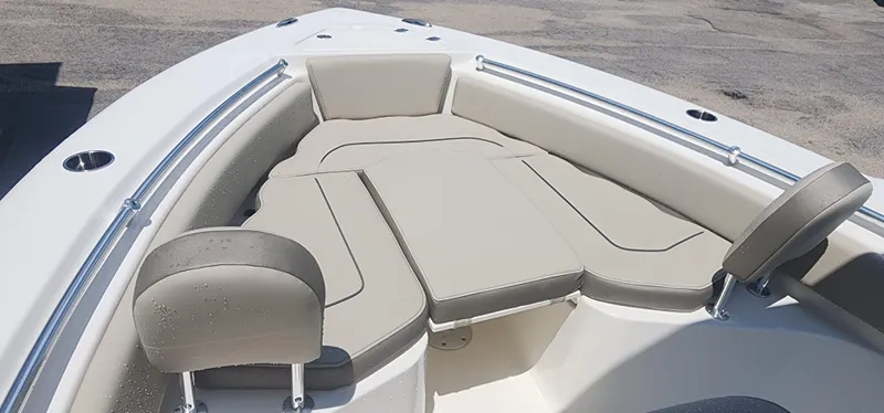 Slide: The Image of 2024 Key West 219fs boat interior with cushioned seating and stainless steel railings. - 20