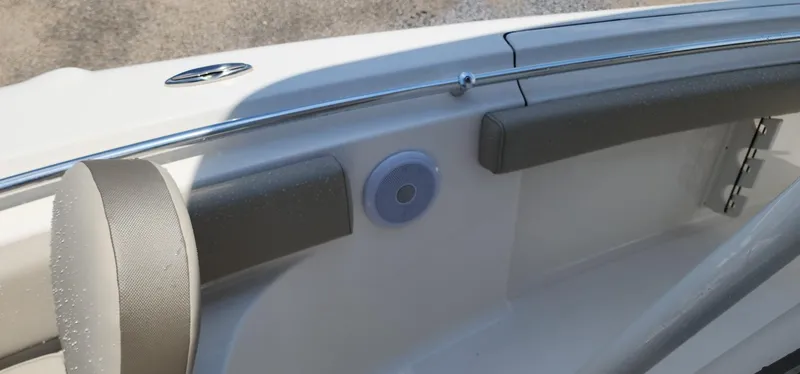 Slide: The Image of 2024 Key West 219fs boat interior with cushioned seating and speaker detail. - 27