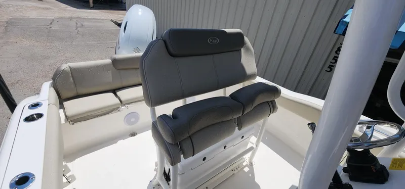 Slide: The Image of 2024 Key West 219fs boat interior with cushioned seating and steering wheel. - 28