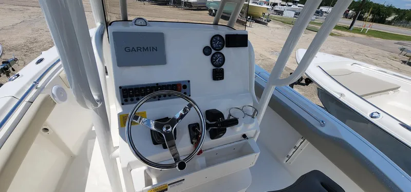 Slide: The Image of 2024 Key West 219fs boat console with Garmin navigation and steering wheel. - 29