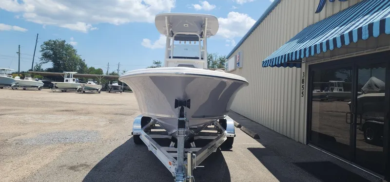 Slide: The Image of 2024 Key West 219fs boat on trailer outside dealership. - 3