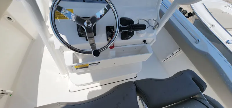 Slide: The Image of 2024 Key West 219fs boat cockpit with steering wheel and controls. - 30
