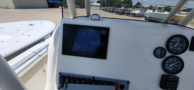 Slide: The Image of 2024 Key West 219fs boat dashboard with gauges and navigation screen. - 32