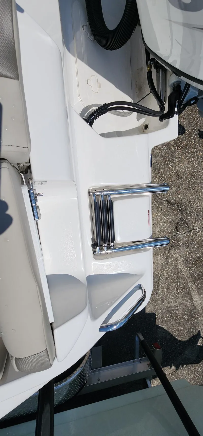 Slide: The Image of 2024 Key West 219fs boat with foldable ladder and seating area. - 47