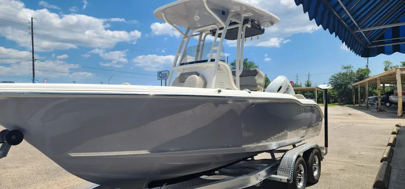 Slide: The Image of 2024 Key West 219fs boat on trailer under blue sky. - 5