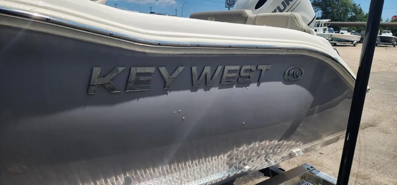 Slide: The Image of 2024 Key West 219fs boat side view with logo in sunlight. - 6