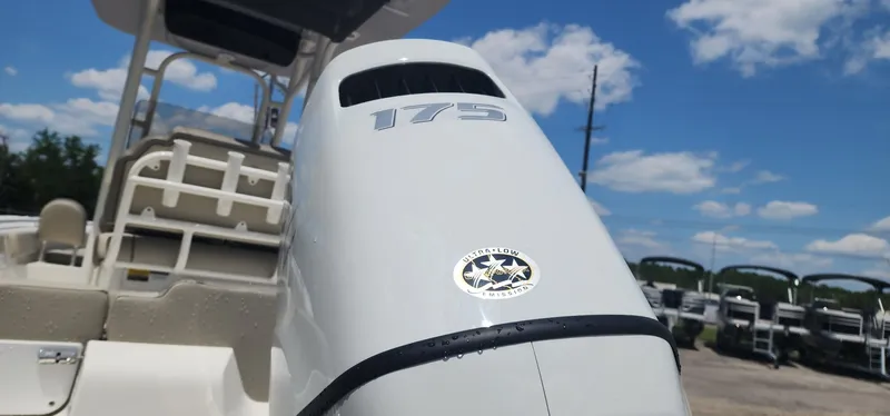Slide: The Image of 2024 Key West 219fs boat with 175 horsepower engine, under clear blue sky. - 9