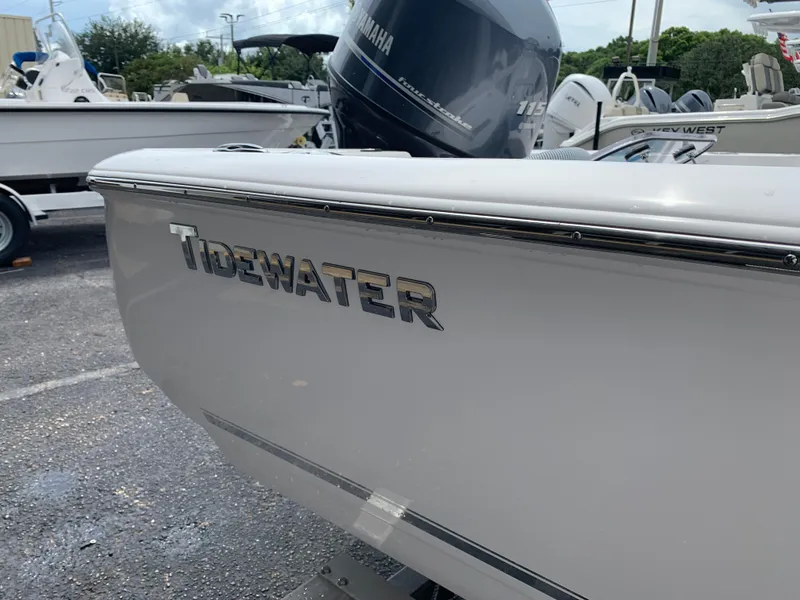 Slide: The Image of 2024 Tidewater 1910BM boat with Yamaha outboard motor in a marina setting. - 10