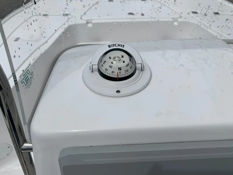 Slide: The Image of Ritchie compass on 2024 Tidewater 1910BM boat console, with water droplets. - 24