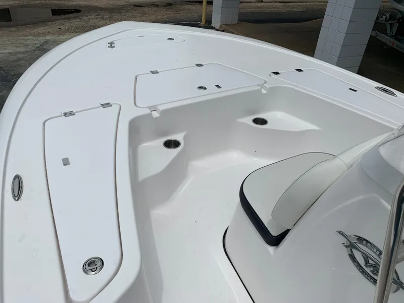 Slide: The Image of 2024 Tidewater 1910BM boat interior, featuring white seating and storage compartments. - 25