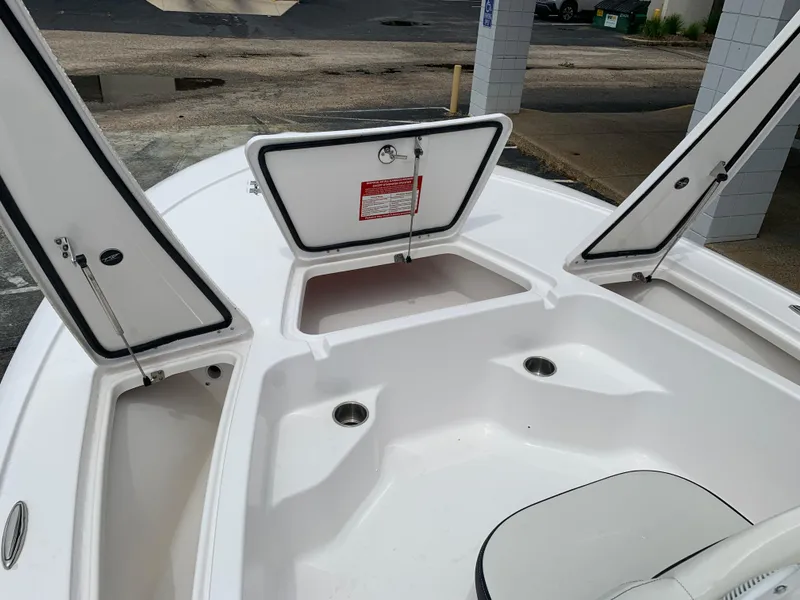 Slide: The Image of 2024 Tidewater 1910BM boat interior with open storage compartments. - 26