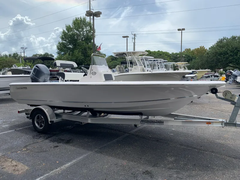 Slide: The Image of 2024 Tidewater 1910BM boat on trailer in parking lot, cloudy sky background. - 8