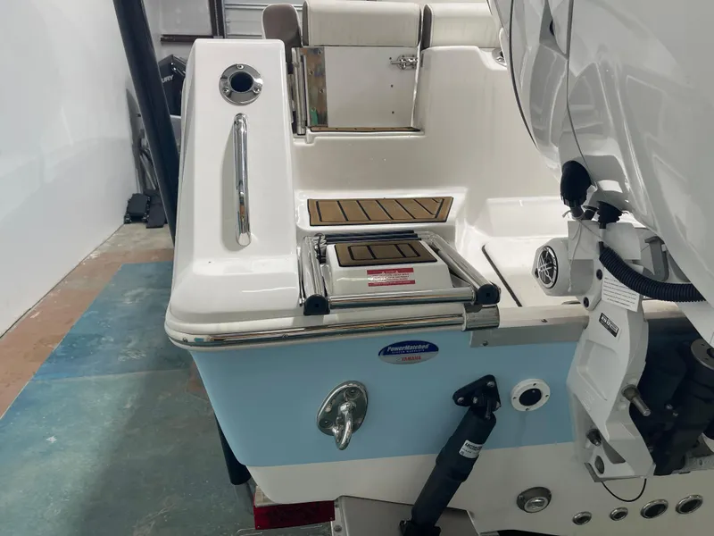 Slide: The Image of 2024 Tidewater 272LXF boat stern with motor and swim platform in a showroom. - 10