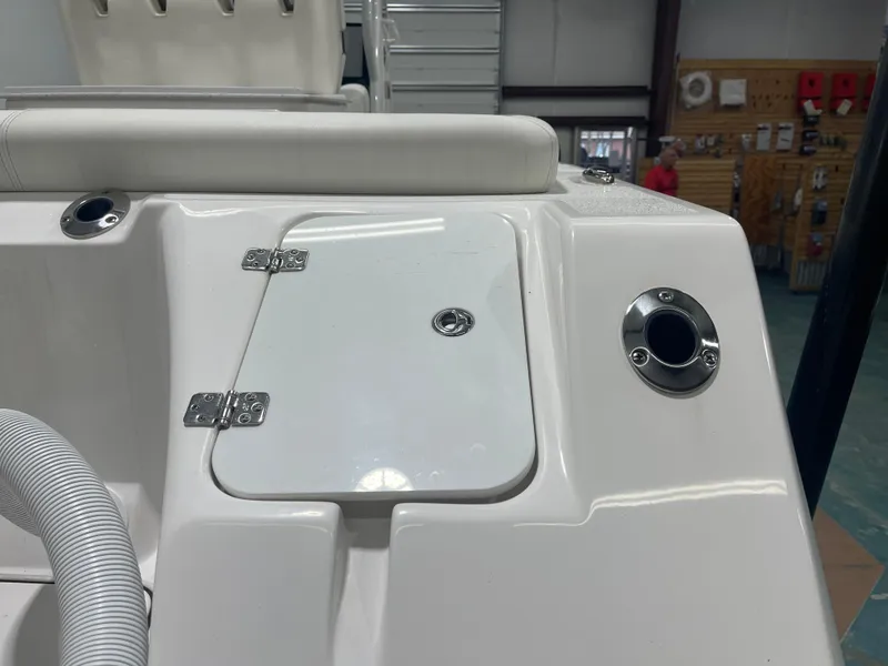 Slide: The Image of 2024 Tidewater 272LXF boat deck with storage compartment and rod holders. - 11