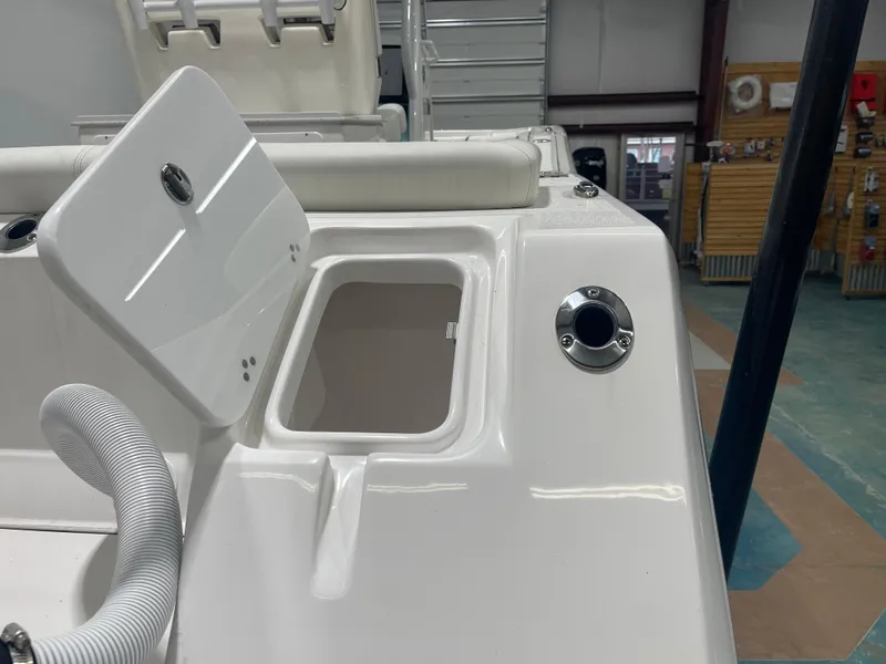 Slide: The Image of 2024 Tidewater 272LXF boat interior with open storage compartment. - 12