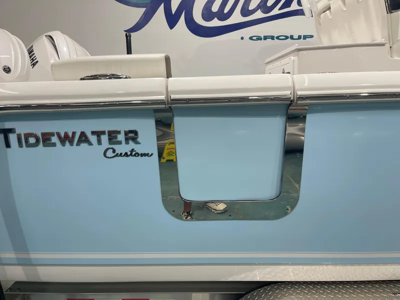 Slide: The Image of 2024 Tidewater 272LXF boat with custom blue detailing and Yamaha engines. - 14