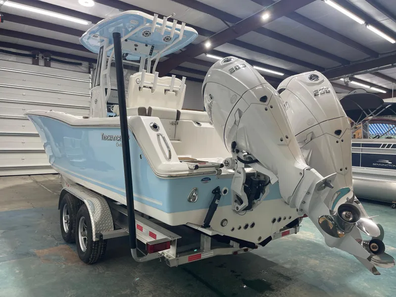 Slide: The Image of 2024 Tidewater 272LXF boat with dual engines in a showroom. - 16