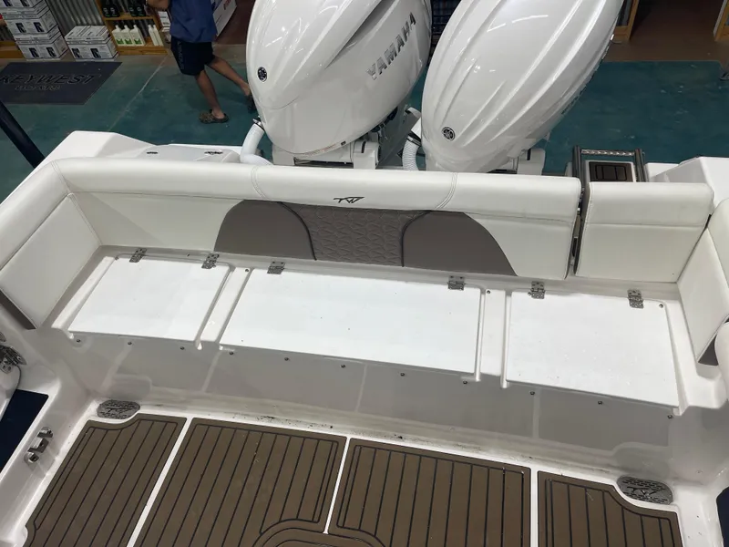 Slide: The Image of 2024 Tidewater 272LXF boat interior with Yamaha engines and cushioned seating. - 17