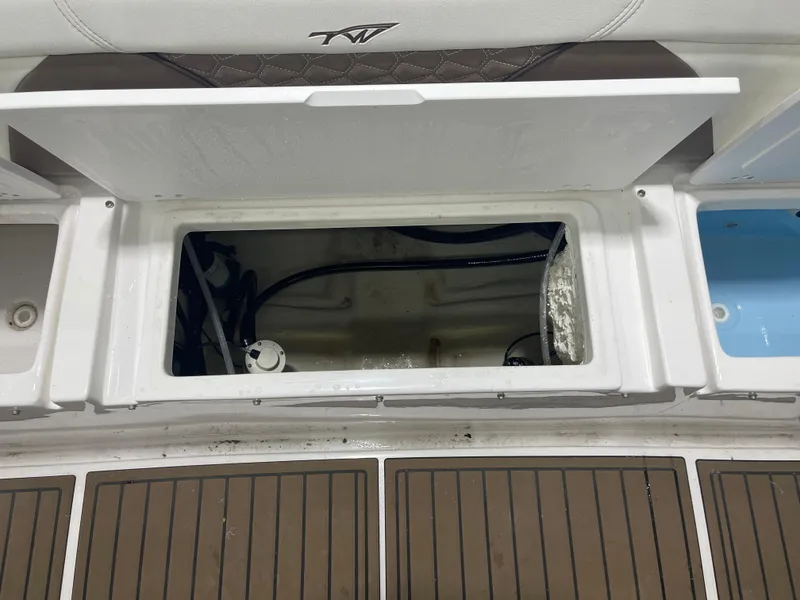 Slide: The Image of Open storage compartment on 2024 Tidewater 272LXF boat, showcasing interior details. - 20