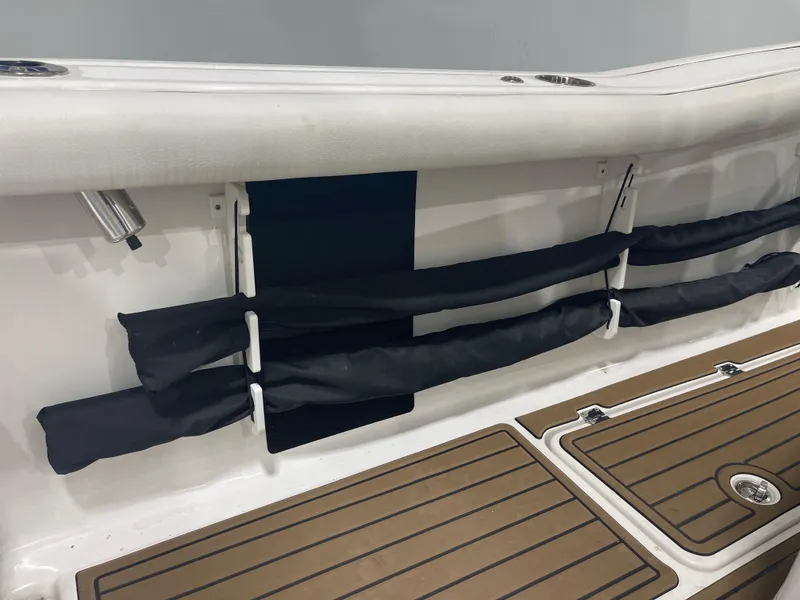 Slide: The Image of 2024 Tidewater 272LXF boat interior with rod holders and teak flooring. - 23