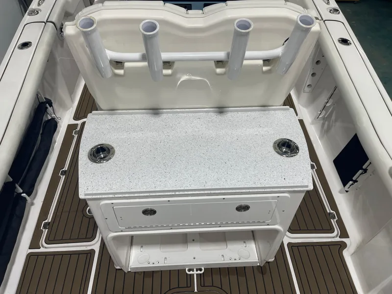 Slide: The Image of 2024 Tidewater 272LXF boat interior with rod holders and storage compartments. - 29