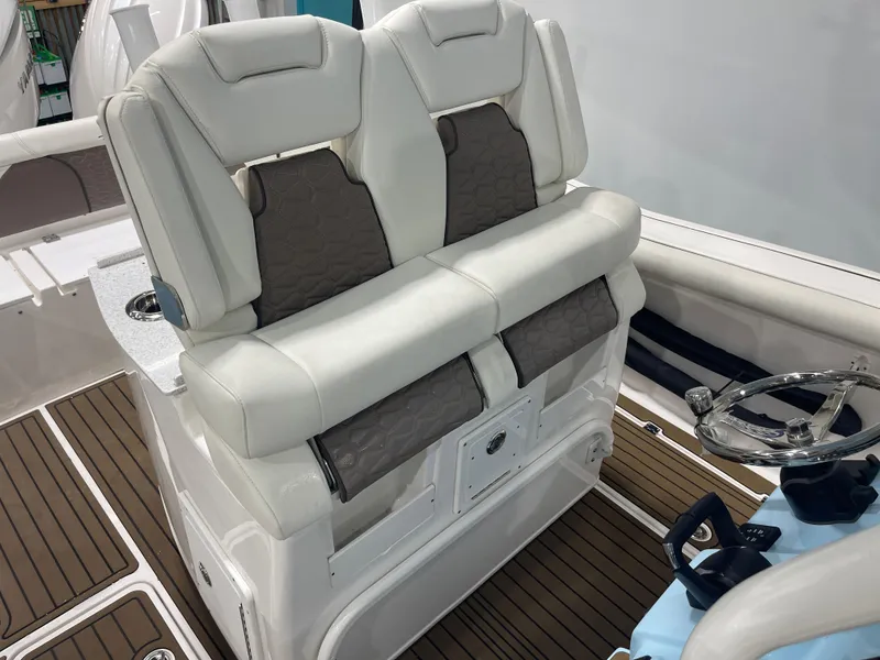 Slide: The Image of 2024 Tidewater 272LXF boat interior with plush seating and modern steering console. - 32
