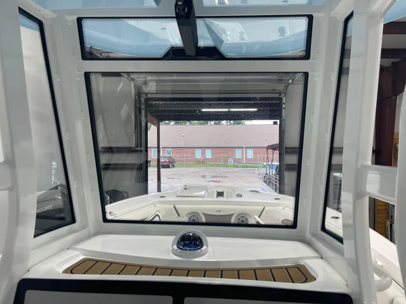 Slide: The Image of 2024 Tidewater 272LXF boat interior view through windshield in a garage. - 33