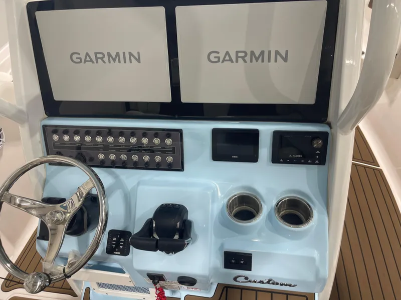 Slide: The Image of 2024 Tidewater 272LXF boat dashboard with Garmin displays and controls. - 35