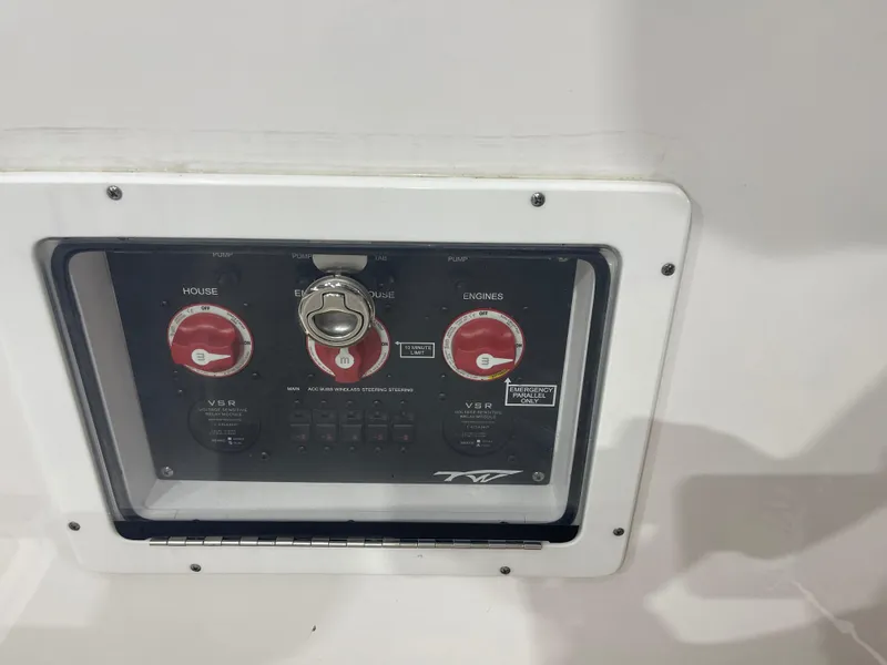 Slide: The Image of 2024 Tidewater 272LXF boat control panel with switches and dials. - 38