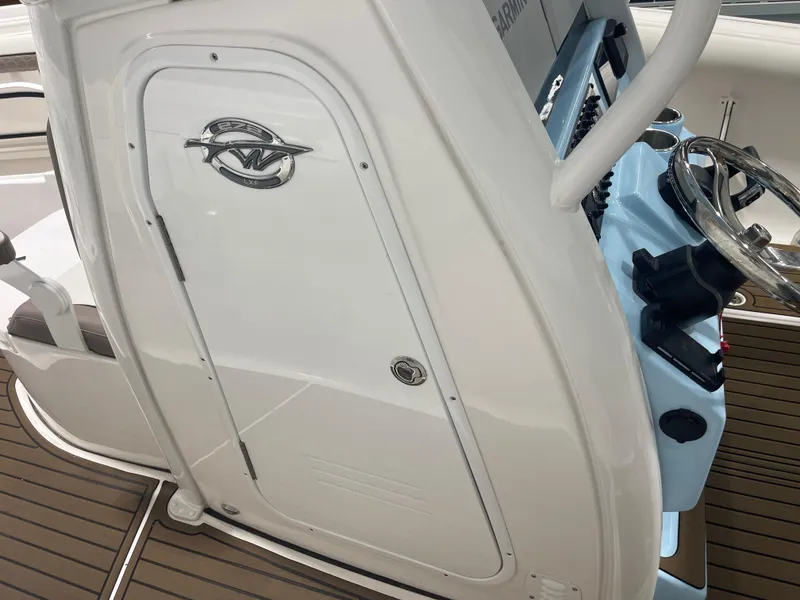 Slide: The Image of 2024 Tidewater 272LXF boat helm with steering wheel and control panel. - 41