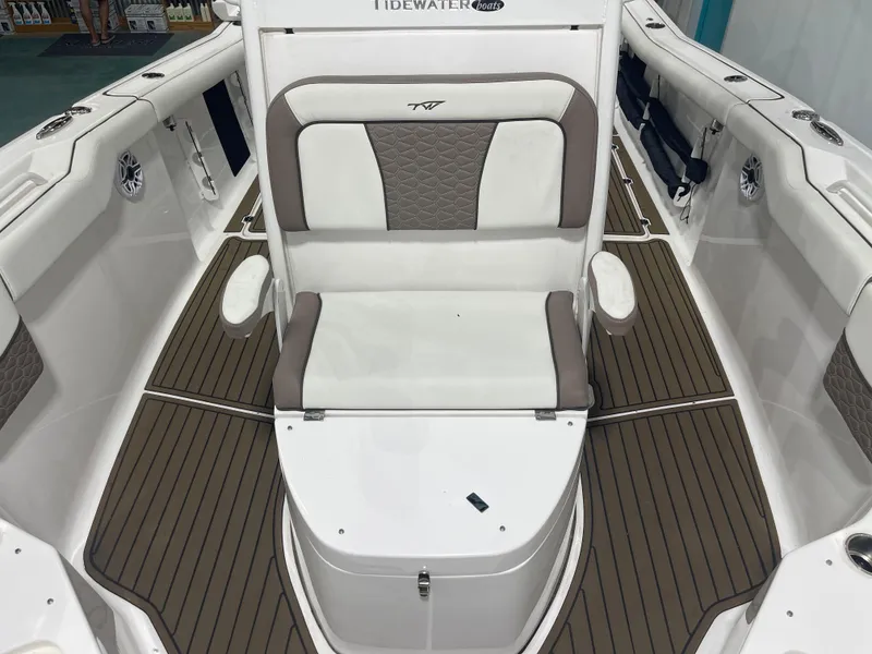 Slide: The Image of 2024 Tidewater 272LXF boat interior with cushioned seating and wood-patterned flooring. - 42