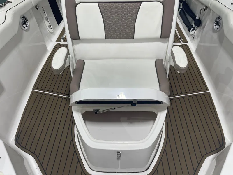 Slide: The Image of 2024 Tidewater 272LXF boat interior with cushioned seating and teak-style flooring. - 43