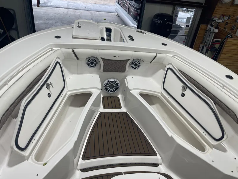 Slide: The Image of 2024 Tidewater 272LXF boat interior with storage compartments and speakers. - 44