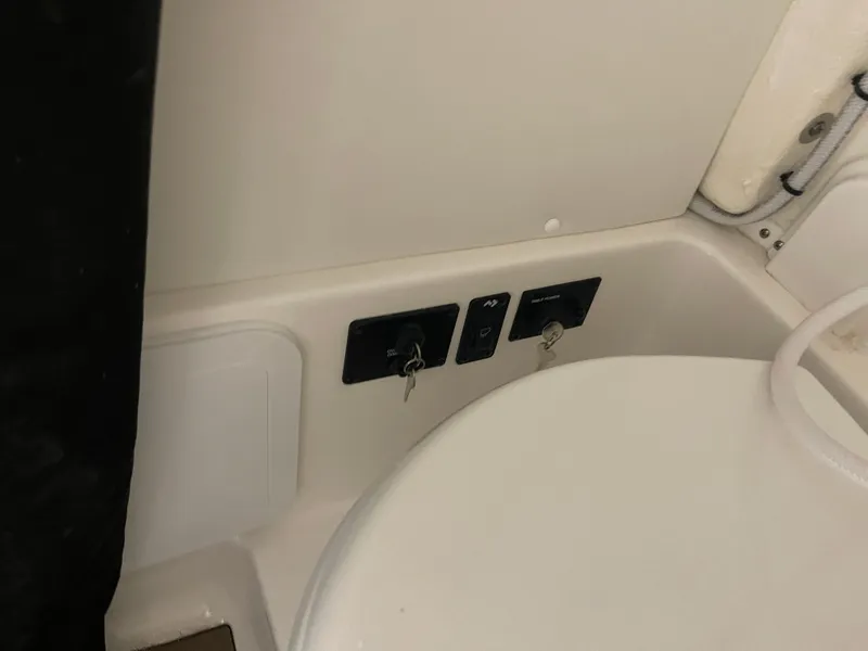 Slide: The Image of 2024 Tidewater 272LXF boat interior with control panel and keys. - 47