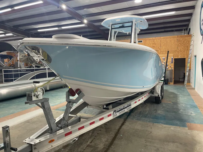 Slide: The Image of 2024 Tidewater 272LXF boat on trailer in indoor showroom. - 5