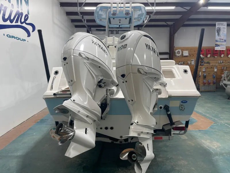 Slide: The Image of 2024 Tidewater 272LXF boat with dual Yamaha outboard engines in a showroom. - 8