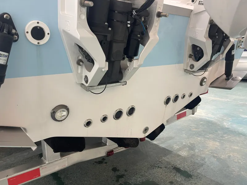 Slide: The Image of 2024 Tidewater 272LXF boat stern with dual outboard motors on a trailer. - 9