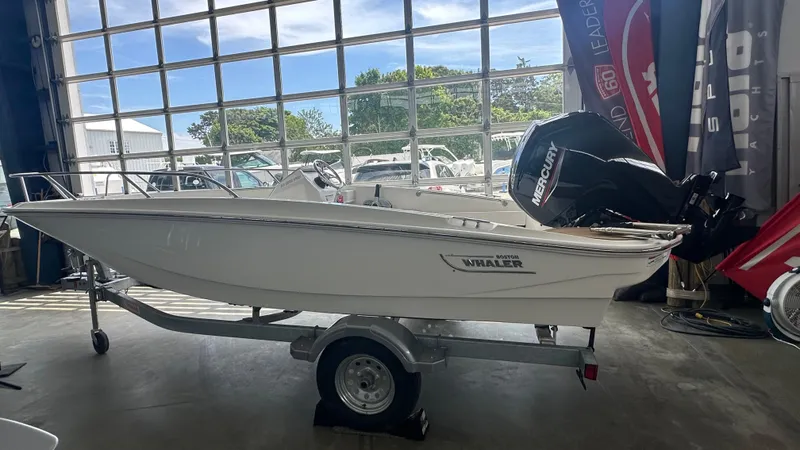 The Image of 2025 Boston Whaler 160 Super Sport boat on trailer in showroom. - 0