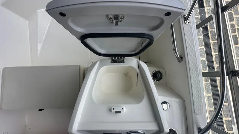 Slide: The Image of 2025 Boston Whaler 160 Super Sport boat interior with open storage compartment. - 12