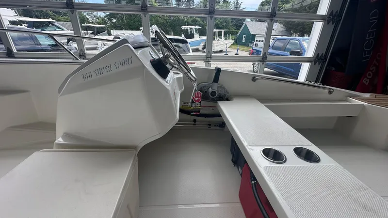 Slide: The Image of 2025 Boston Whaler 160 Super Sport interior with steering console and seating area. - 13
