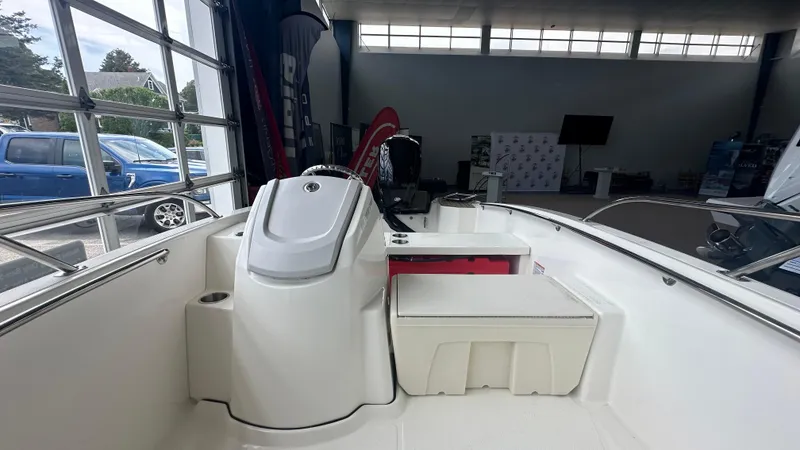 Slide: The Image of 2025 Boston Whaler 160 Super Sport interior view in showroom setting. - 15