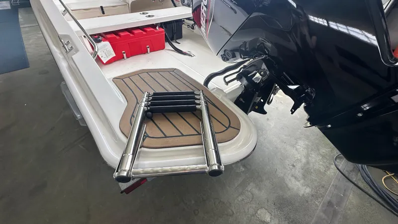 Slide: The Image of 2025 Boston Whaler 160 Super Sport boat with ladder and outboard motor. - 4